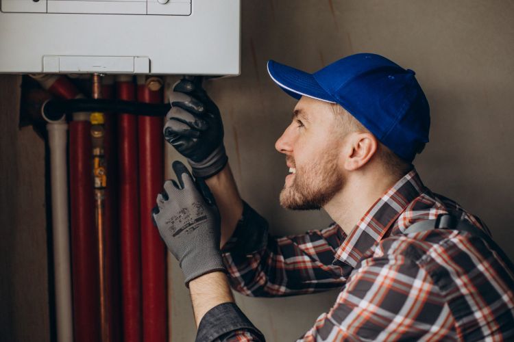 hvac tech repairing air conditioning
